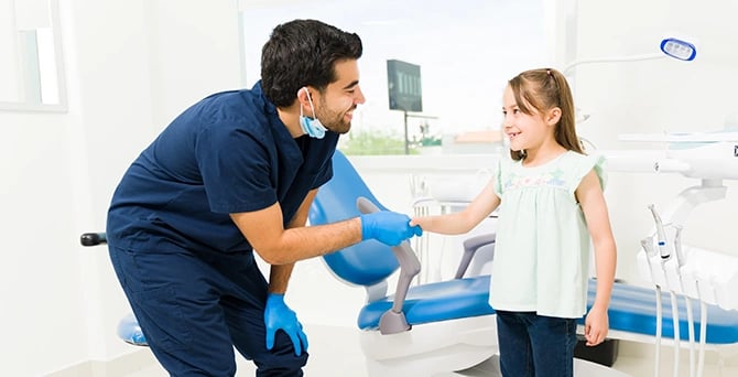 dentist shaking hands with little girl
