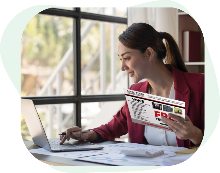 Woman_Sitting_At_Desk_Reading_A_Direct_Mail_Postcard