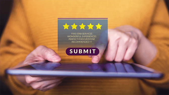 Close up image of tablet with finger pointed to it and a five star review as a pop up