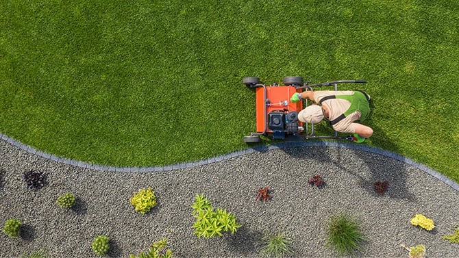 Top view of landscaper and a lawn mower