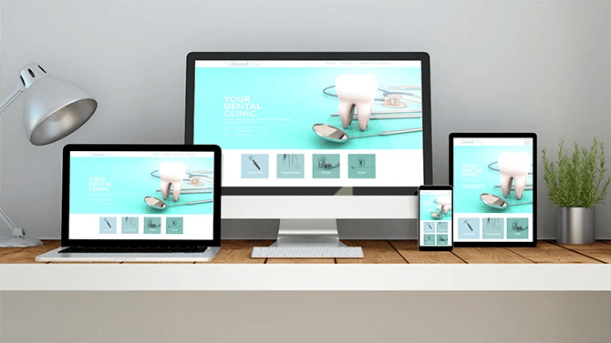 Dental website displayed on a laptop, desktop, mobile phone and tablet.