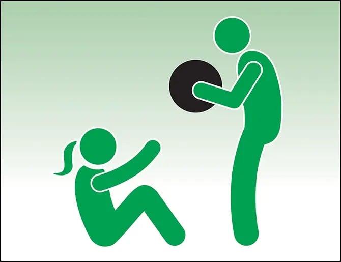 trainer doing medicine ball exercises with a client