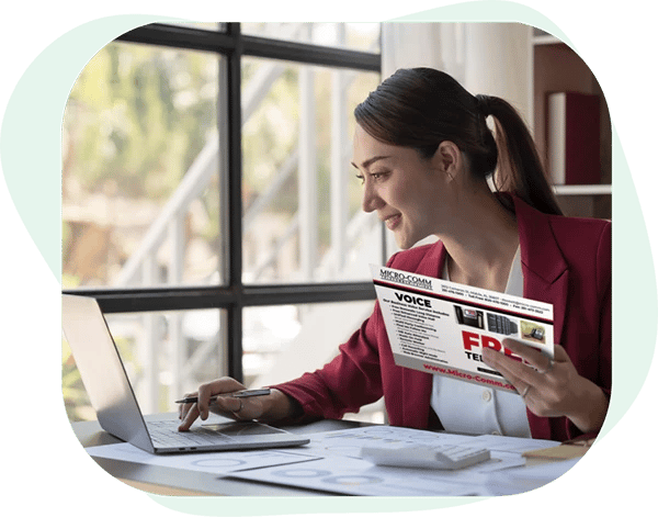 Woman_Sitting_At_Desk_Reading_A_Direct_Mail_Postcard