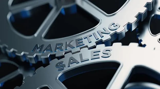 Gears labeled Marketing and Sales turning together