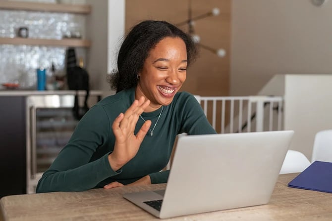 Mixed-race woman using a laptop to stay connected with church congregation
