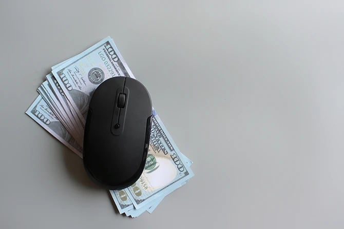 US dollar and computer mouse illustrating Facebook ads or display ads pay per click.