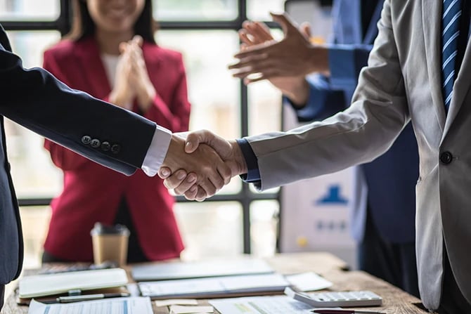 Business partner handshake after a meeting.