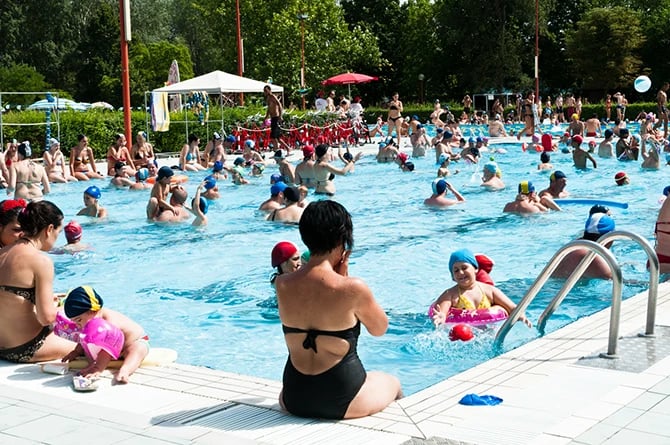 A full public pool on a hot summer day