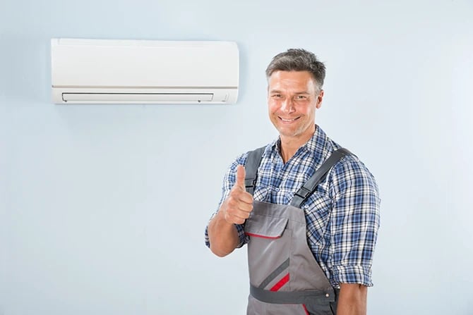 Portrait of a male air conditioning technician gesturing thumb up