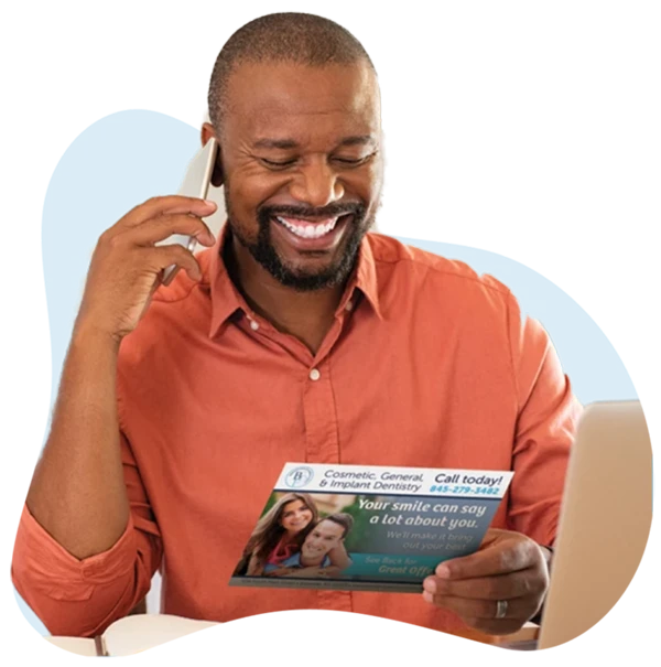Man responding to a direct mail postcard by calling dental office